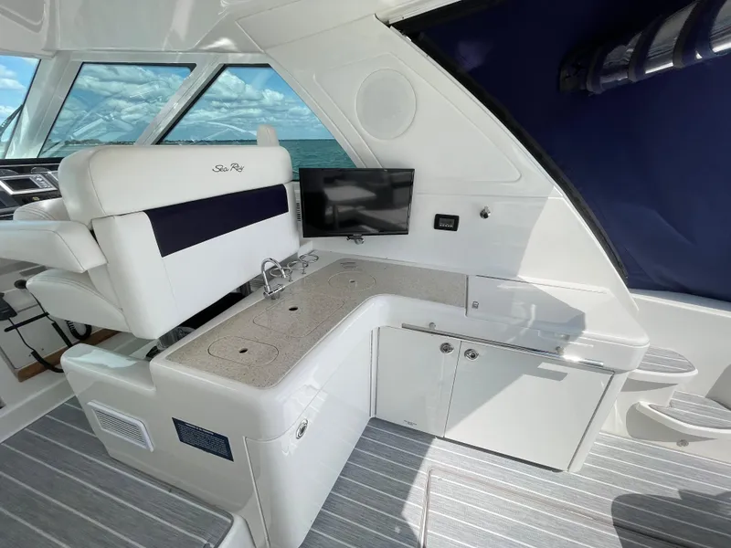 Slide: The Image of Interior of 2010 Sea Ray 450 Sundancer yacht with seating, TV, and kitchenette. - 38