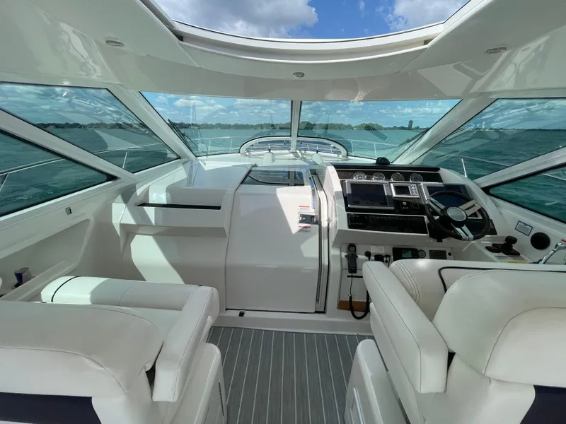 Slide: The Image of Interior view of 2010 Sea Ray 450 Sundancer yacht cockpit with modern controls. - 39