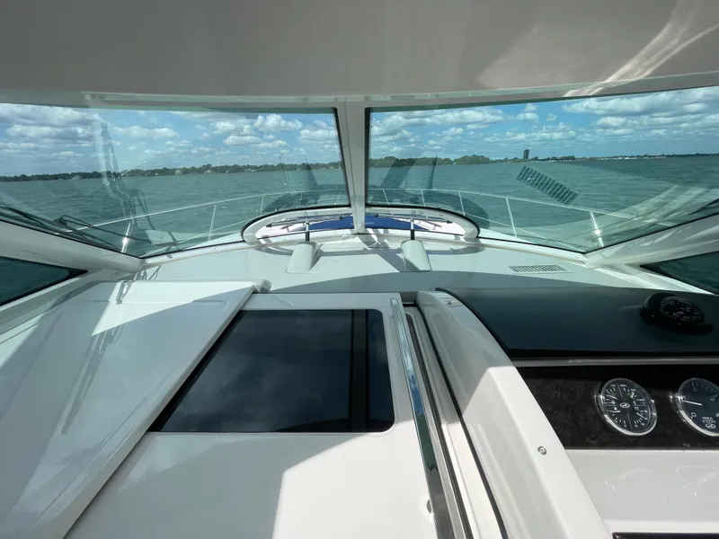 Slide: The Image of Cockpit view of 2010 Sea Ray 450 Sundancer yacht on open water. - 44
