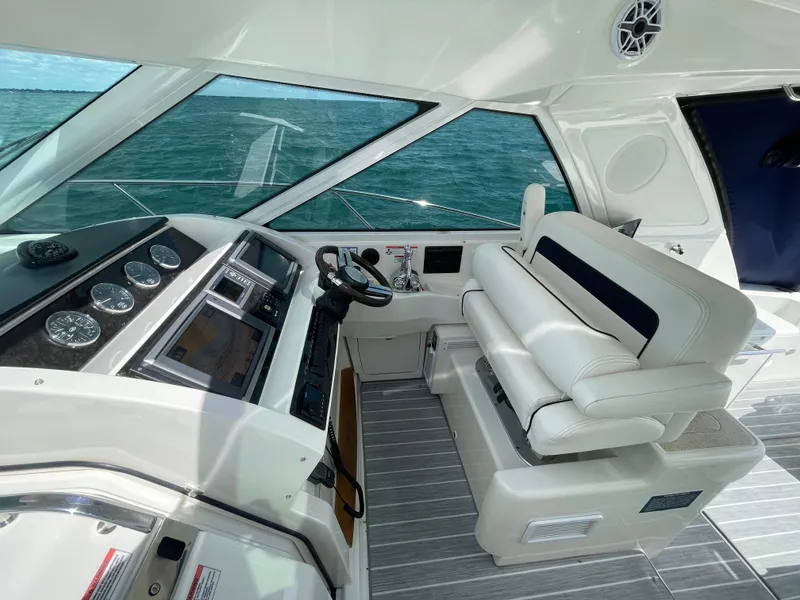 Slide: The Image of Interior view of 2010 Sea Ray 450 Sundancer yacht helm with modern controls and seating. - 45
