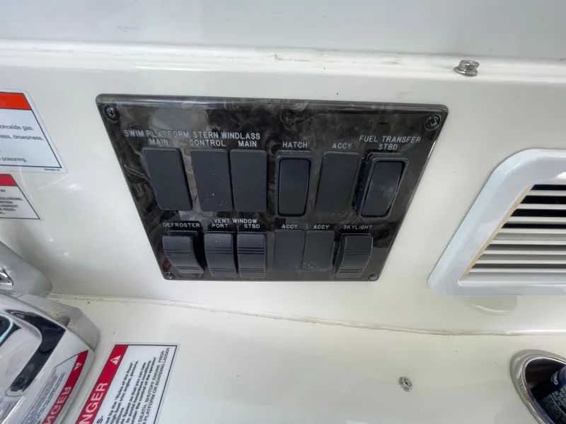 Slide: The Image of Control panel on a 2010 Sea Ray 450 Sundancer boat with labeled switches. - 47