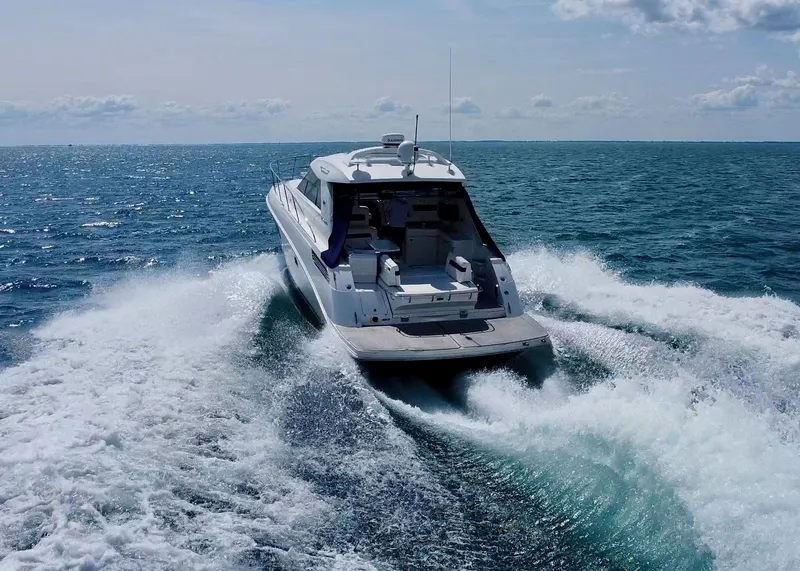 Slide: The Image of Sea Ray 450 Sundancer 2010 cruising on open water, creating waves behind. - 7