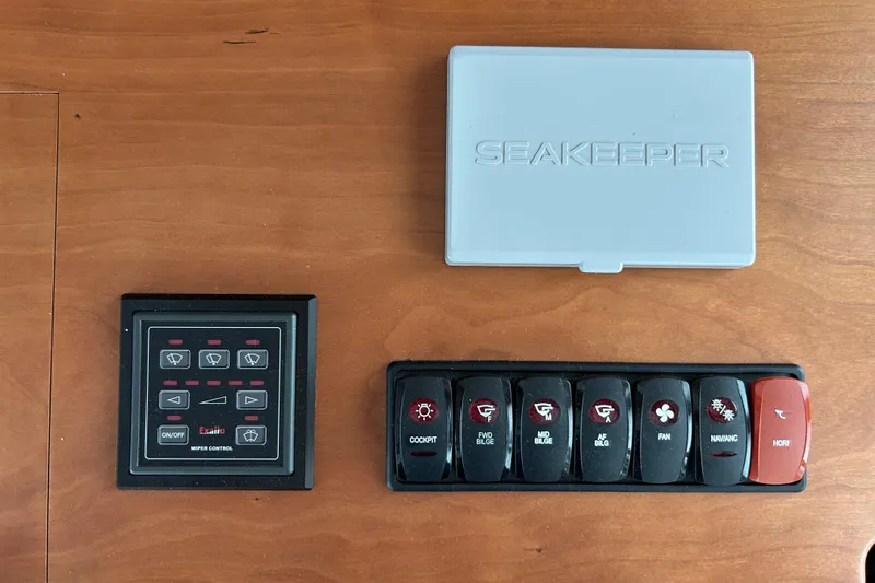 Slide: The Image of Interior of 2022 Sabre 45 Salon Express yacht with white leather seating and wooden accents. - 17