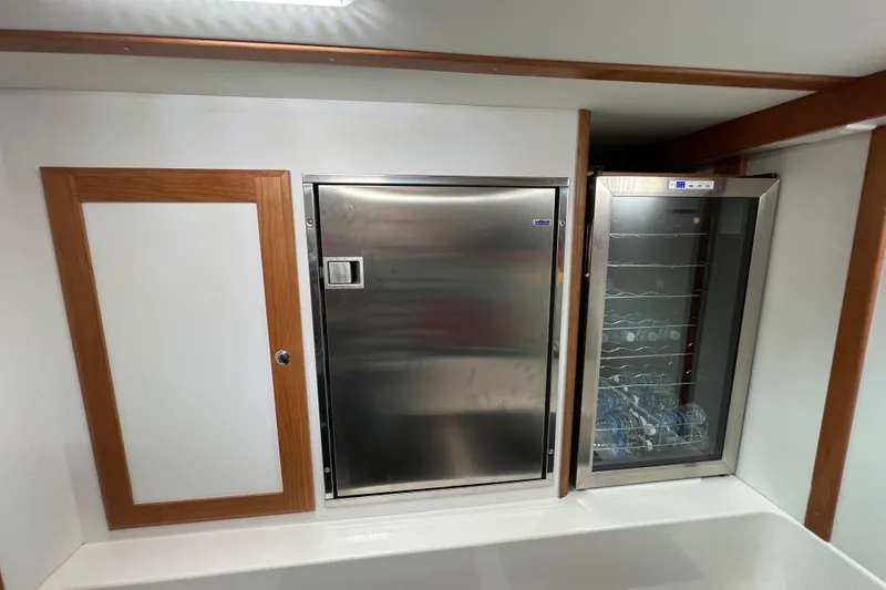 Slide: The Image of Control panel of a 2022 Sabre 45 Salon Express with generator hour meter and switches. - 26