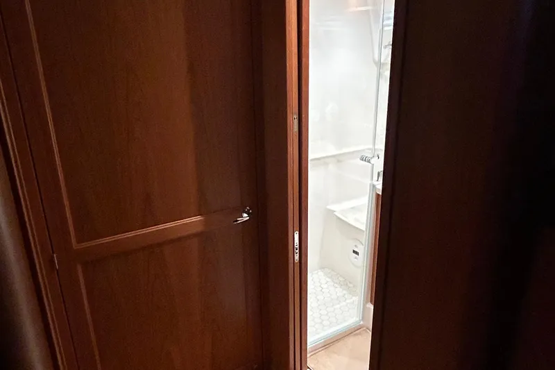 Slide: The Image of Interior of 2022 Sabre 45 Salon Express yacht, featuring elegant wood cabinetry and modern appliances. - 36