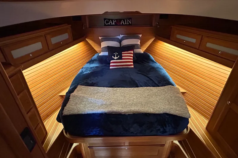Slide: The Image of Interior of 2022 Sabre 45 Salon Express yacht, featuring cozy bedroom with nautical decor. - 38