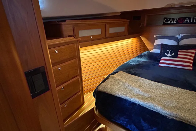 Slide: The Image of Interior view of 2022 Sabre 45 Salon Express bathroom with wooden door and shower. - 40