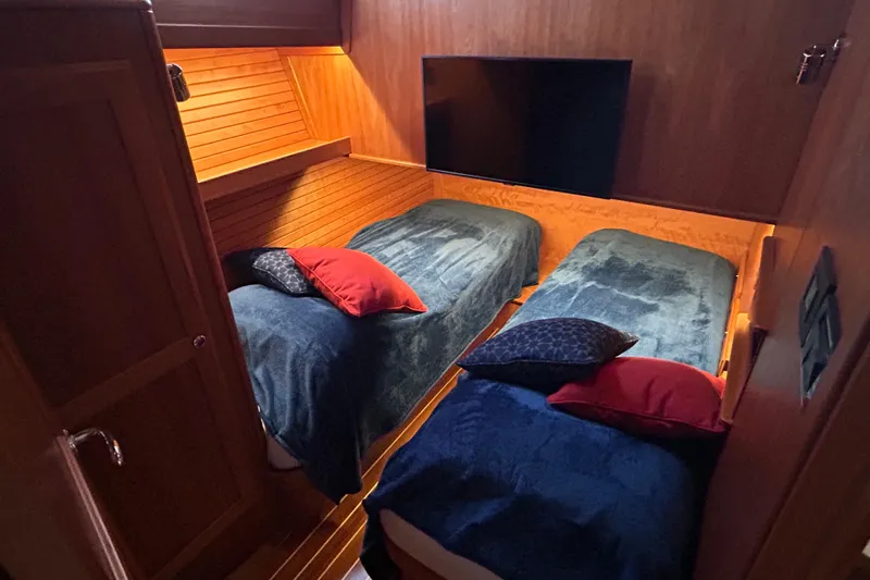Slide: The Image of Cozy cabin interior of 2022 Sabre 45 Salon Express with nautical-themed bedding. - 43