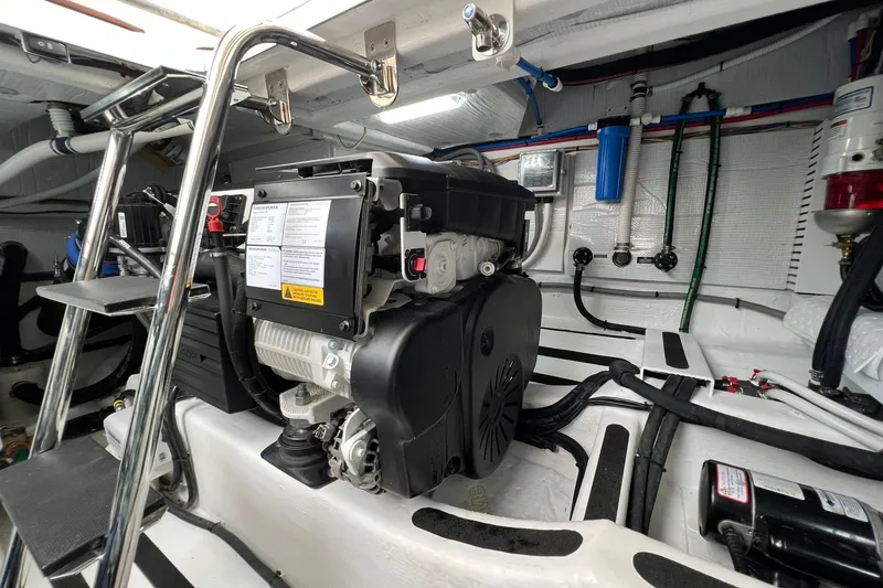 Slide: The Image of Engine room of 2022 Sabre 45 Salon Express with visible hoses and components. - 48