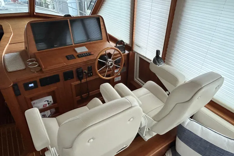 Slide: The Image of Interior helm of 2022 Sabre 45 Salon Express with dual seats and navigation controls. - 67