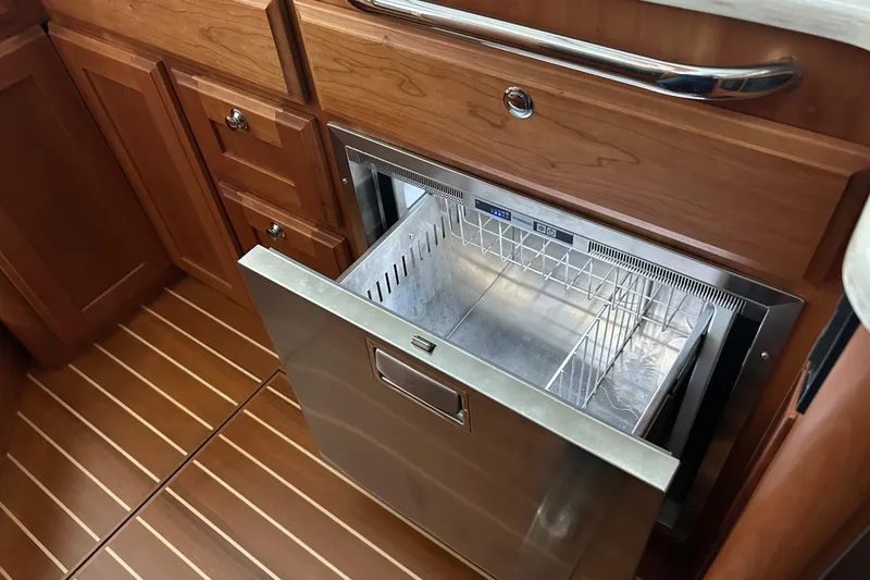 Slide: The Image of Open drawer refrigerator in 2022 Sabre 45 Salon Express yacht kitchen. - 68