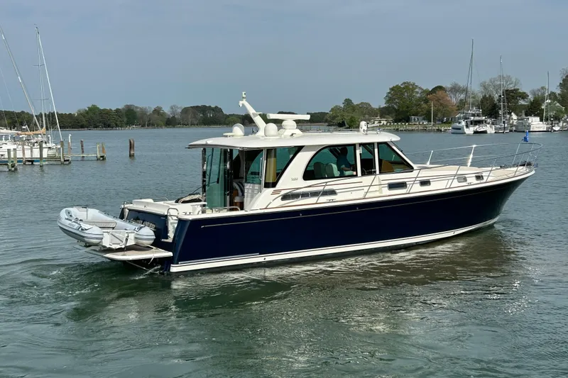 Slide: The Image of 2022 Sabre 45 Salon Express yacht cruising on a calm waterway. - 69