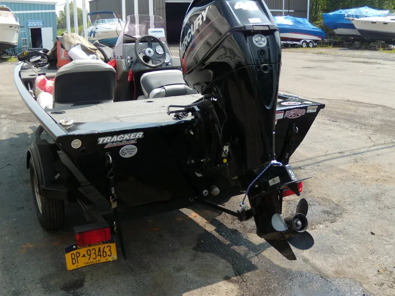 Slide: The Image of 2018 Tracker Pro 160 boat with Mercury outboard motor, parked on a trailer. - 3