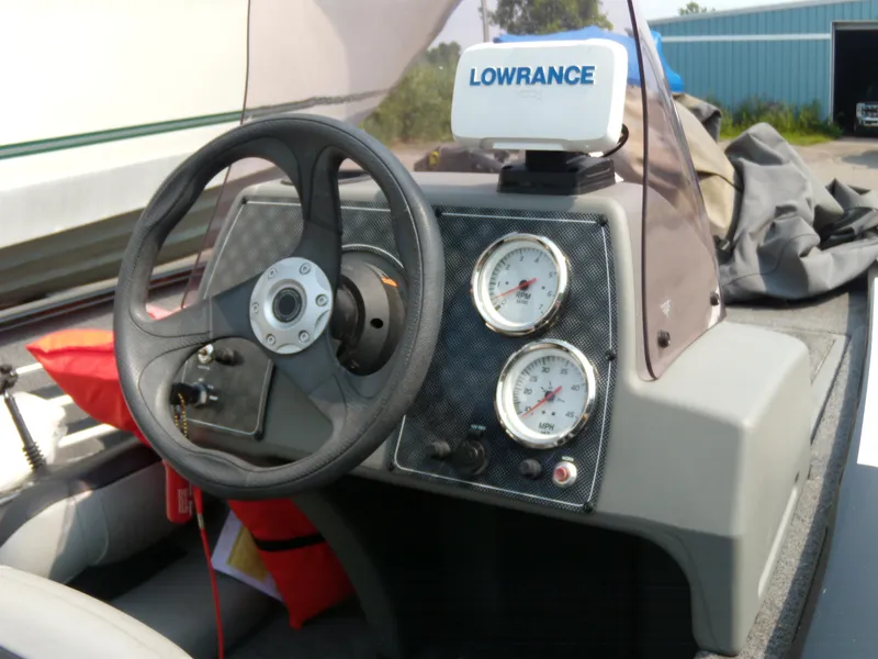 Slide: The Image of 2018 Tracker Pro 160 boat dashboard with steering wheel and gauges. - 6