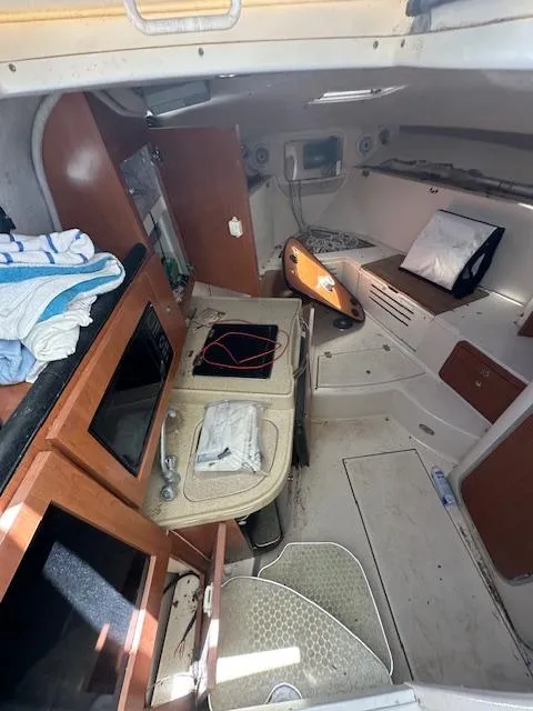 Slide: The Image of 2005 Wellcraft 290 Coastal cabin interior with kitchenette and seating area. - 10