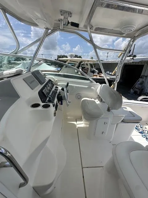 Slide: The Image of 2005 Wellcraft 290 Coastal boat interior with steering console and seating. - 11