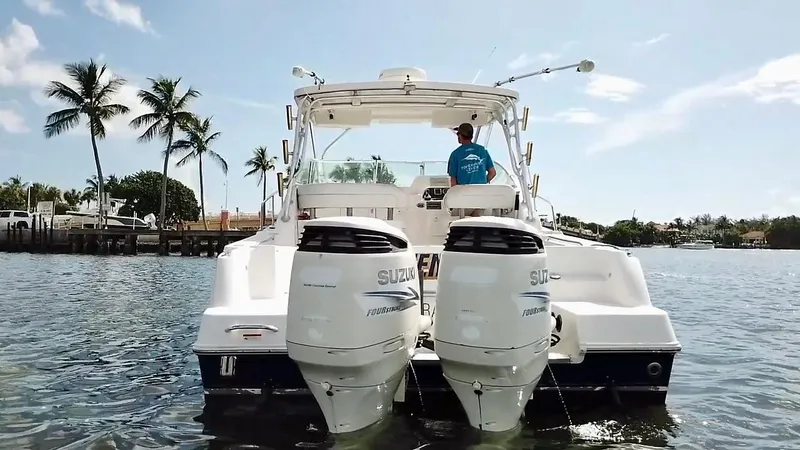 Slide: The Image of 2005 Wellcraft 290 Coastal boat with dual Suzuki engines on a sunny day. - 3