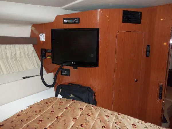 Slide: The Image of Interior of 2009 Regal Commodore 4060 yacht with TV and wood paneling. - 18