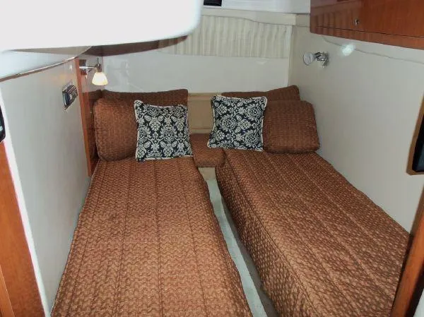 Slide: The Image of Twin beds in 2009 Regal Commodore 4060 cabin with patterned pillows and brown bedding. - 19
