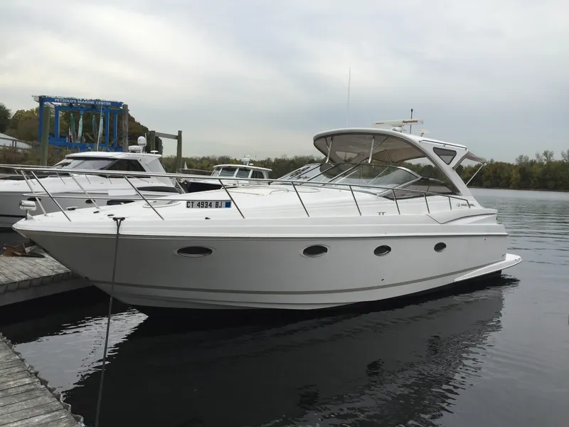 Slide: The Image of 2009 Regal Commodore 4060 yacht docked at marina, side view. - 2