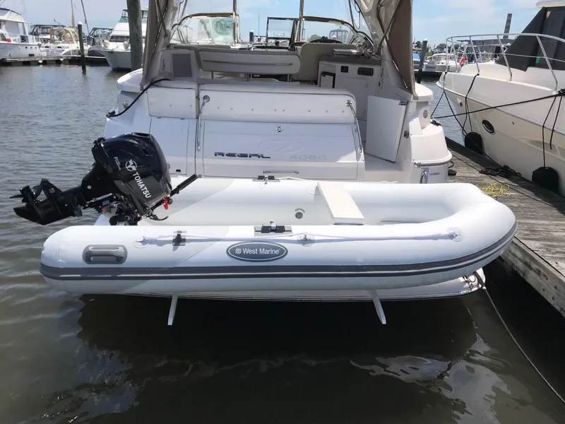 Slide: The Image of 2009 Regal Commodore 4060 yacht with inflatable West Marine dinghy at marina. - 24