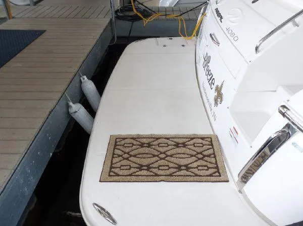 Slide: The Image of 2009 Regal Commodore 4060 yacht docked with decorative mat on deck. - 25