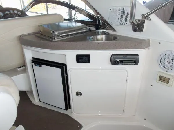 Slide: The Image of 2009 Regal Commodore 4060 yacht interior with kitchenette, sink, and mini fridge. - 7