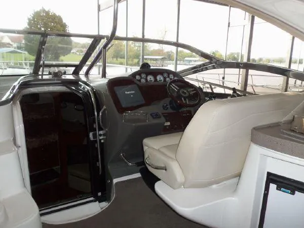 Slide: The Image of 2009 Regal Commodore 4060 boat interior with helm, steering wheel, and seating. - 9