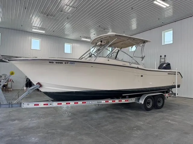 The Image of 2011 Grady-White Freedom 275 boat on trailer in indoor storage facility. - 0