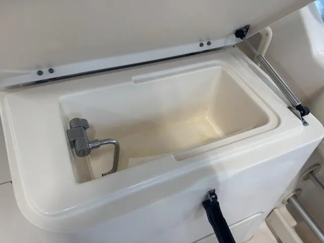 Slide: The Image of Livewell compartment on a 2011 Grady-White Freedom 275 boat, featuring a faucet. - 11