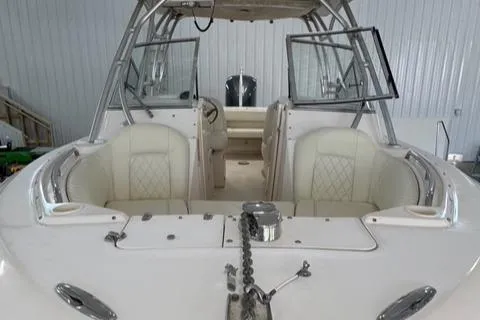 Slide: The Image of 2011 Grady-White Freedom 275 boat interior with white seating and open windshield. - 16