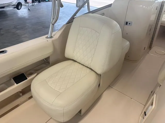 Slide: The Image of 2011 Grady-White Freedom 275 boat interior with cream leather seating. - 18