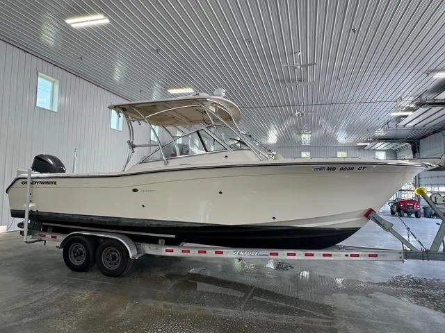 Slide: The Image of 2011 Grady-White Freedom 275 boat on trailer in indoor storage facility. - 2