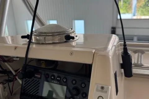 Slide: The Image of 2011 Grady-White Freedom 275 boat dashboard with radio and antenna. - 24