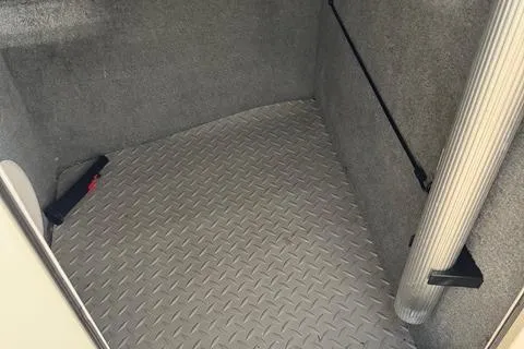 Slide: The Image of 2011 Grady-White Freedom 275 interior with diamond-patterned flooring and storage space. - 25