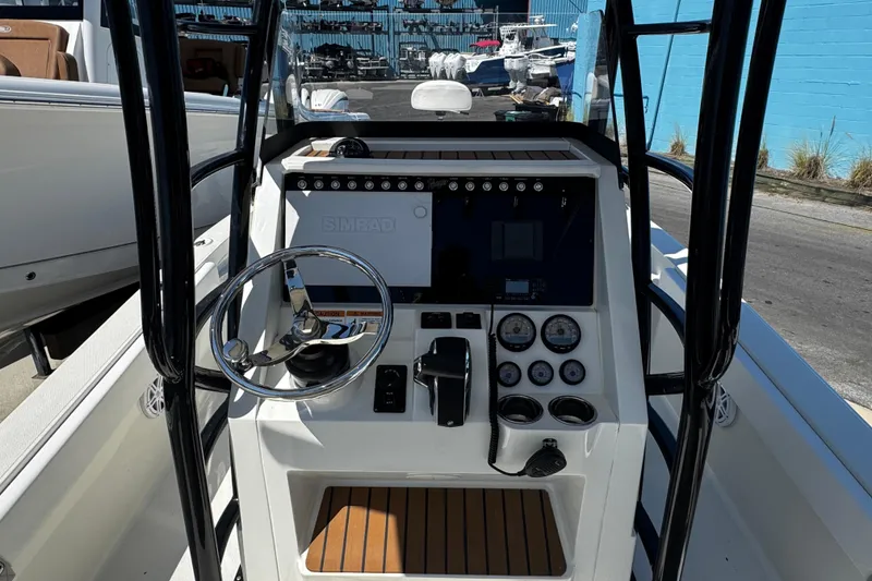 Slide: The Image of 2023 Ranger 2510 Bay boat console with steering wheel and navigation controls. - 13