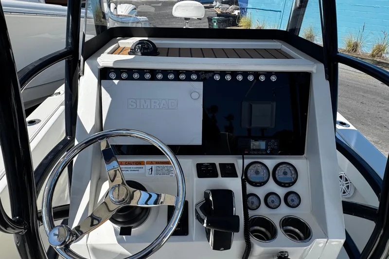Slide: The Image of 2023 Ranger 2510 Bay boat dashboard with steering wheel and control panel. - 14