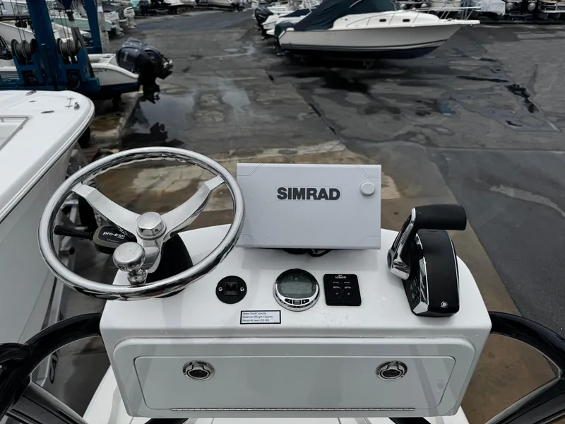 Slide: The Image of 2023 Ranger 2510 Bay boat console with Simrad navigation system and steering wheel. - 22