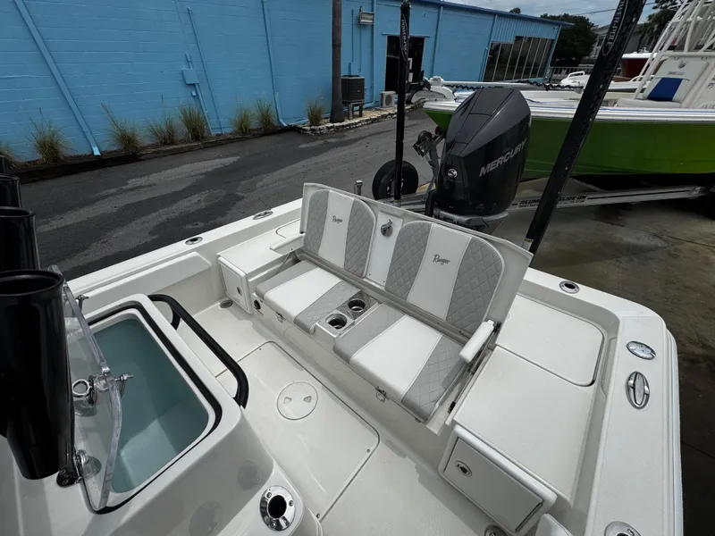 Slide: The Image of 2023 Ranger 2510 Bay boat interior with seating and Mercury engine. - 26