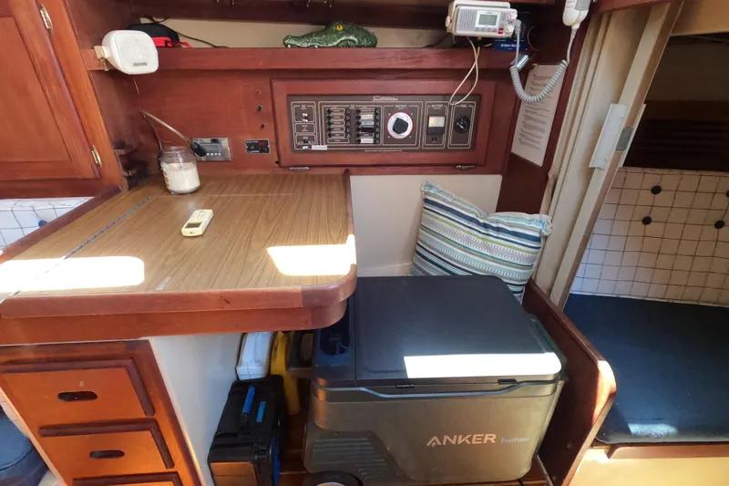 Slide: The Image of Interior of a 1983 Catalina 36 sailboat with navigation station and Anker cooler. - 11