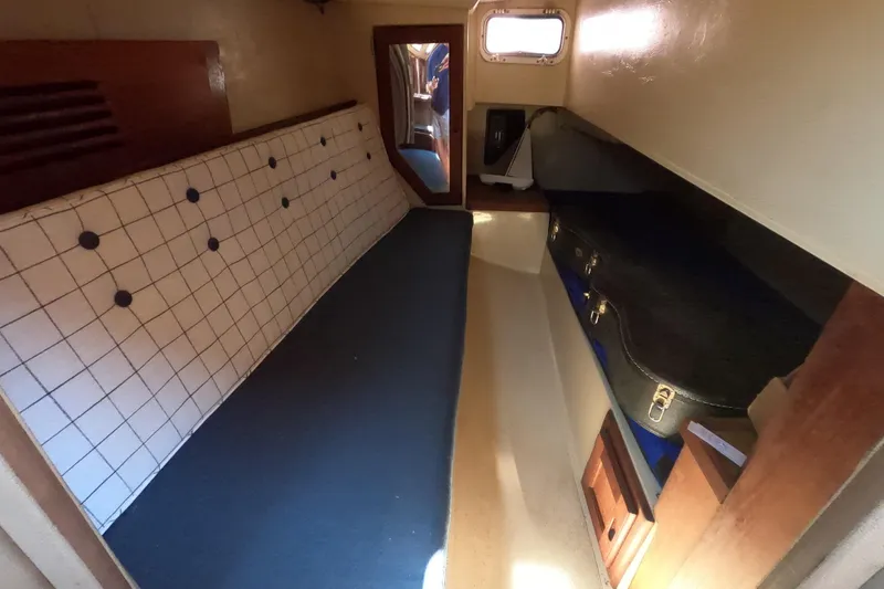 Slide: The Image of Interior cabin of a 1983 Catalina 36 sailboat with seating and storage. - 13