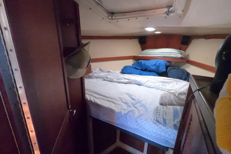 Slide: The Image of Cozy cabin interior of 1983 Catalina 36 sailboat with bed and wooden furnishings. - 22