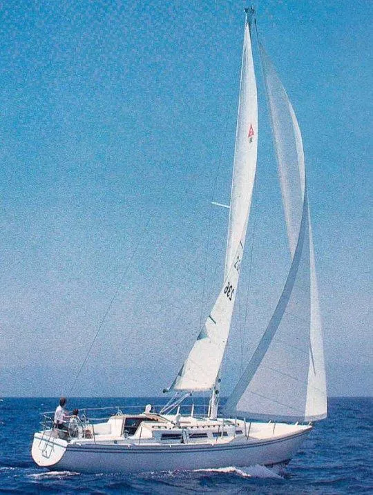 Slide: The Image of 1983 Catalina 36 sailboat cruising on open water under clear blue skies. - 29