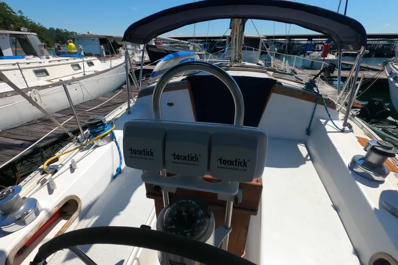 Slide: The Image of Cockpit view of a 1983 Catalina 36 sailboat docked at a marina. - 7