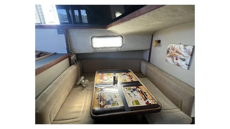Slide: The Image of 1986 Carver 3607 Aft Cabin interior with bed, mirror, and sink. Cozy and functional design. - 12