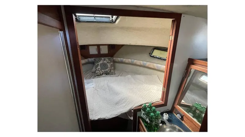 Slide: The Image of 1986 Carver 3607 Aft Cabin interior with stairs leading to cozy bedroom. - 14