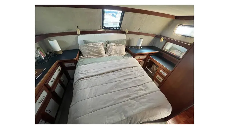 Slide: The Image of 1986 Carver 3607 Aft Cabin interior with desk, drawers, and window. - 17