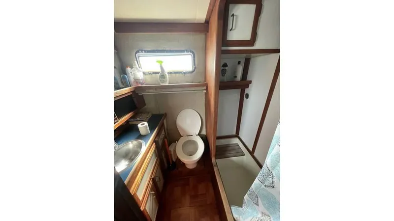 Slide: The Image of Closet inside 1986 Carver 3607 Aft Cabin with hanging clothes and cleaning tools. - 18