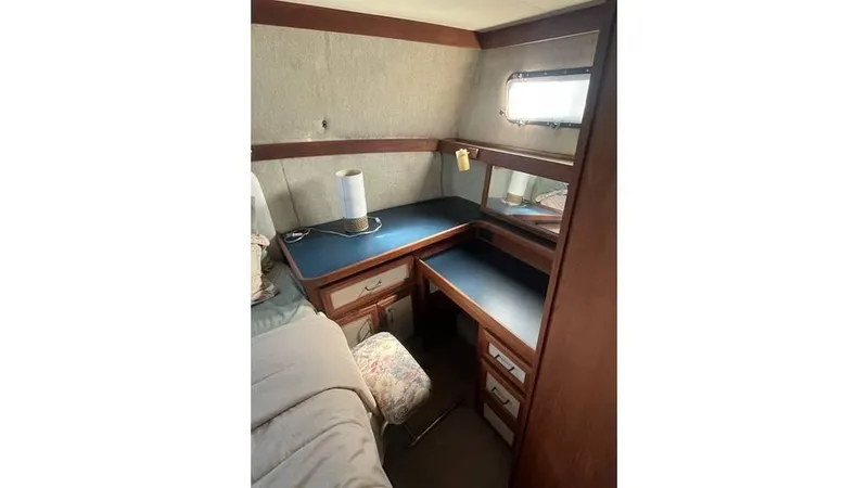 Slide: The Image of 1986 Carver 3607 Aft Cabin helm with steering wheel, control panel, and gauges. - 19