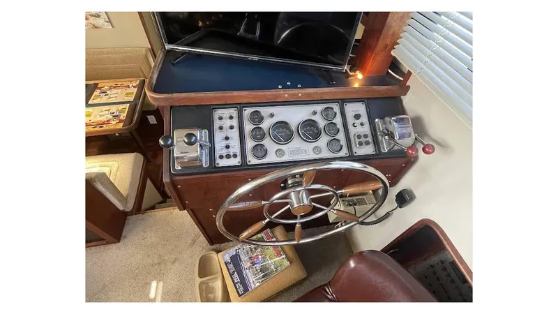 Slide: The Image of 1986 Carver 3607 Aft Cabin Motor Yacht on calm water, featuring spacious deck. - 21